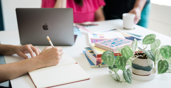 Photo of R&R team member writing in a notebook