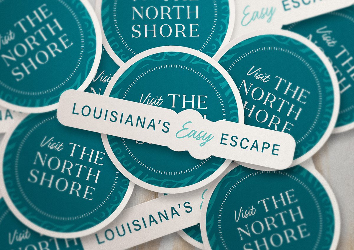 Stack of stickers with the Visit The Northshore logo and tagline