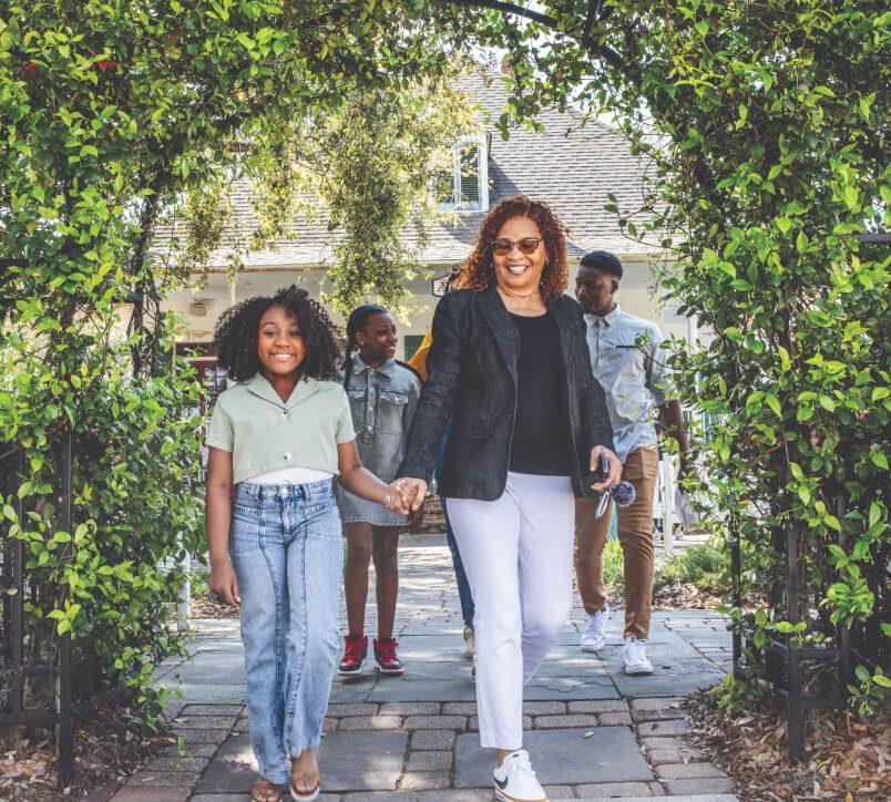 Family walking under arch of ivy