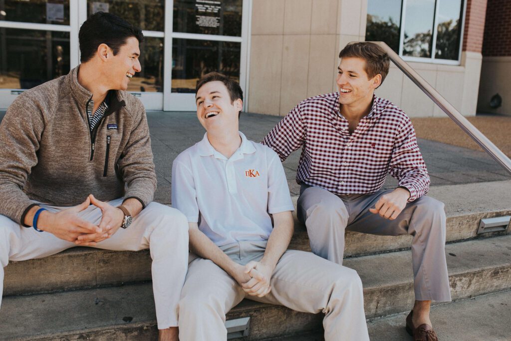 Group of Pike brothers smiling sitting on steps