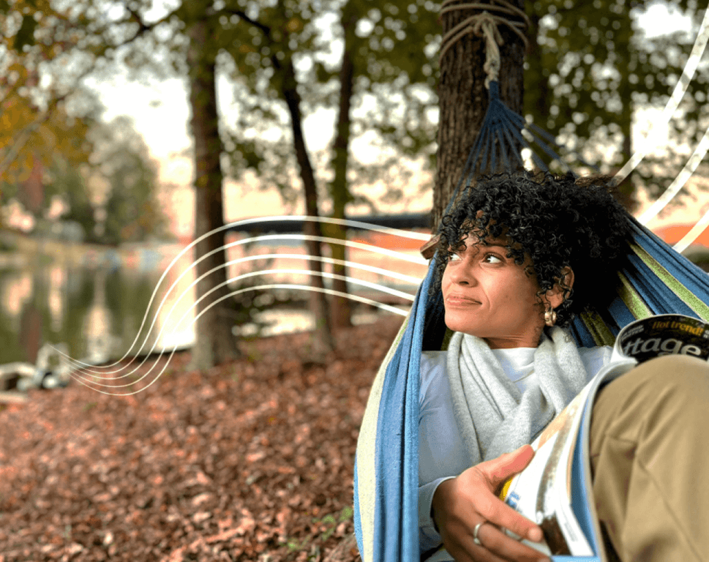 Photo of a woman in a hammock by the lake on a fall day