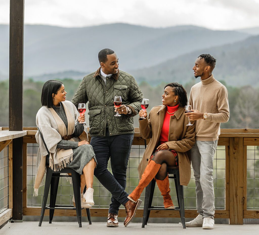 A group of friends enjoy wine in the mountains of Ellijay, GA